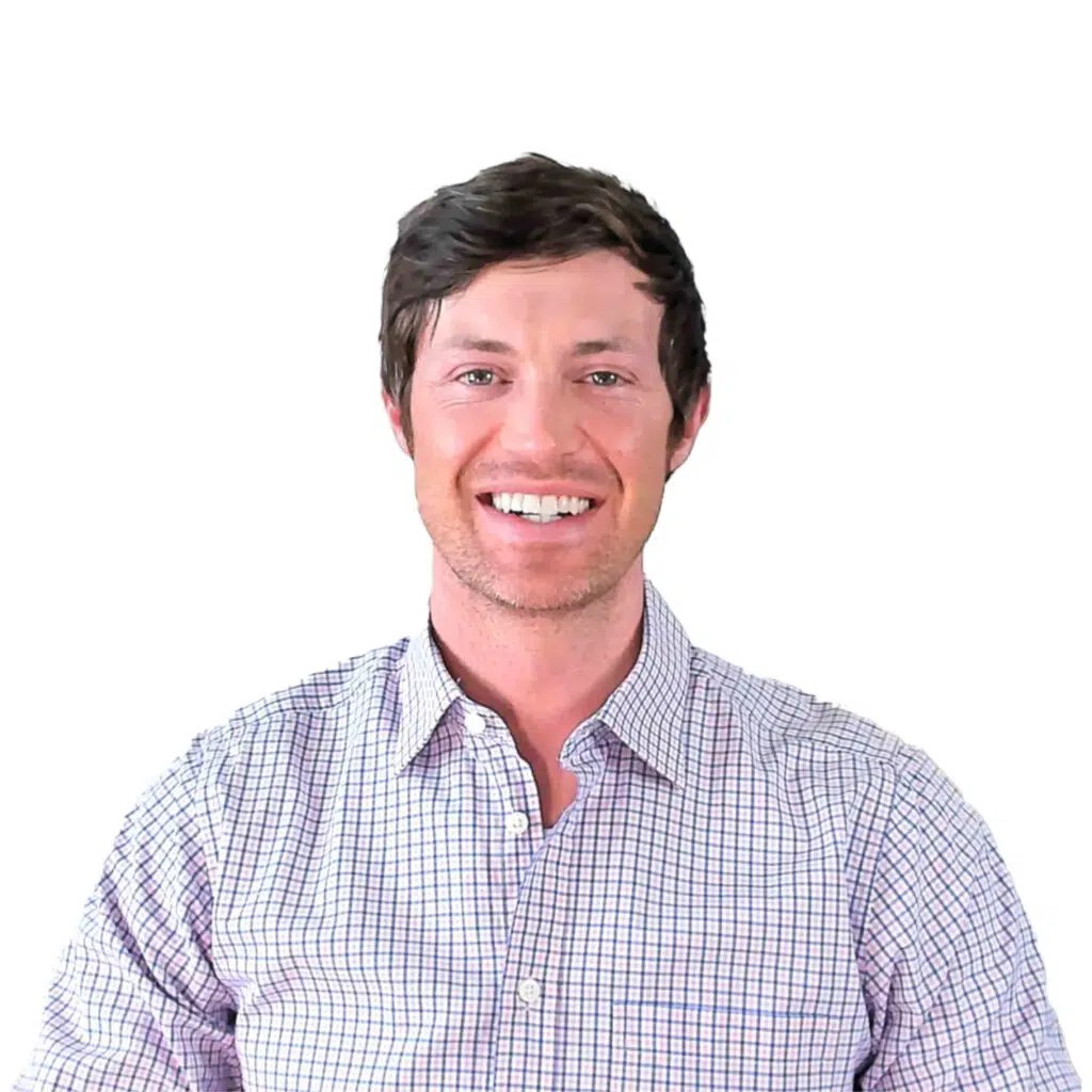 dr. westin childs sitting down smiling in a button up shirt.